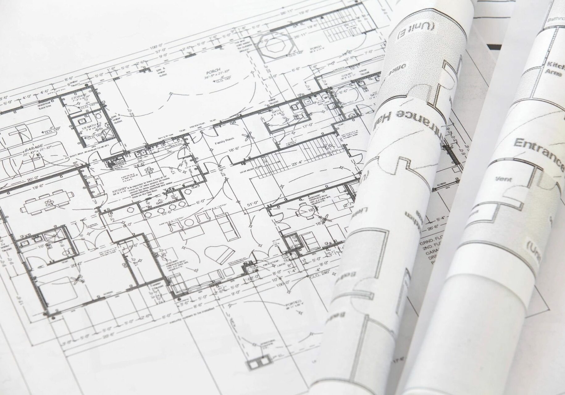 A roll of architectural plans sitting on top of a book.